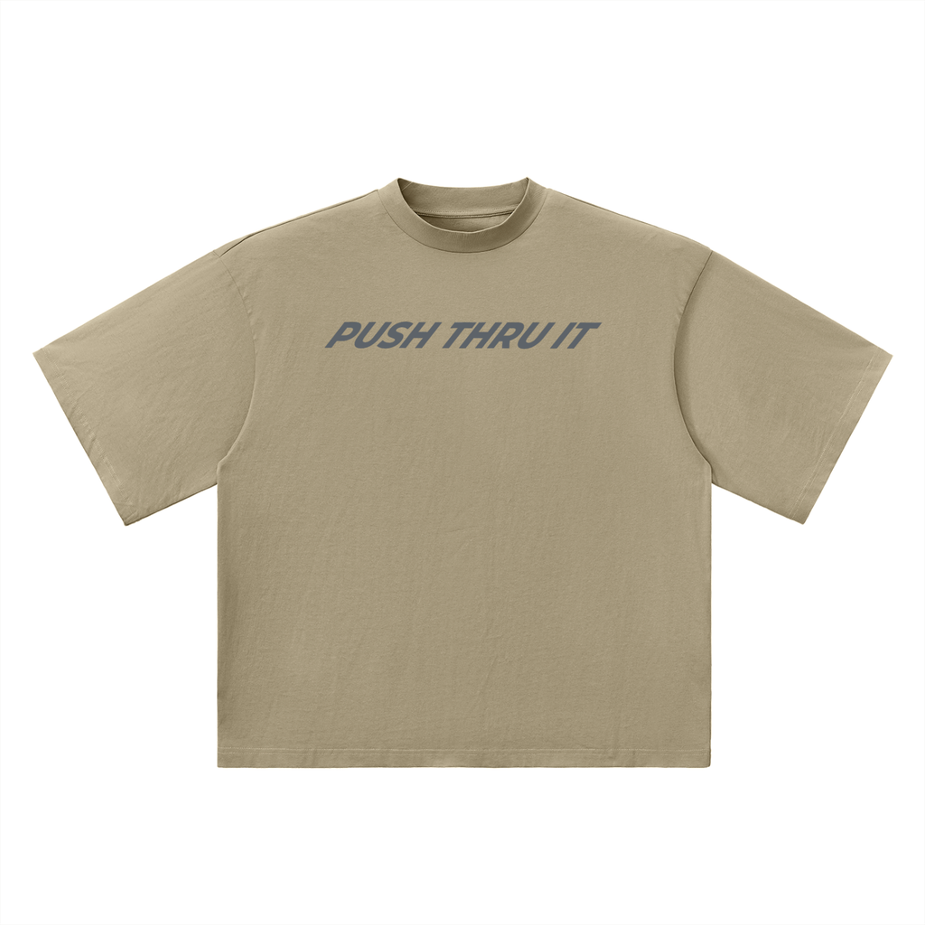 Beige t-shirt with a small slanted lettering "Push Thru It" logo across chest on a white background