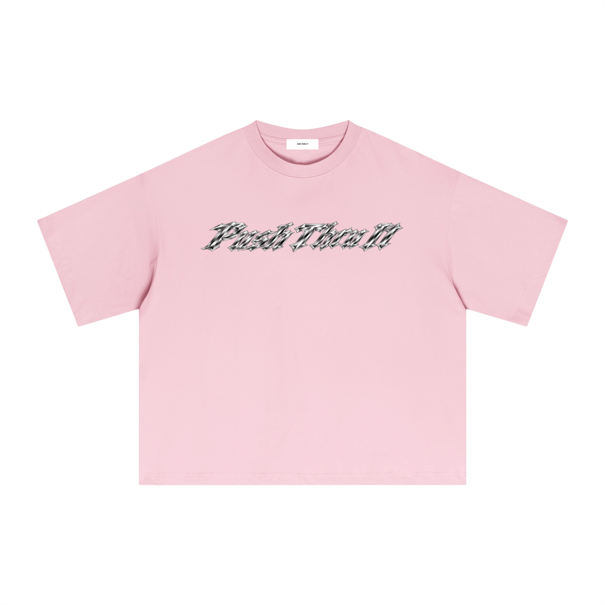 A light pink short-sleeve crewneck t-shirt with a stylized metallic graphic text across the chest reading 'PUSH THRU IT', displayed flat against a solid white background.